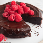 A tempting slice of Flourless Chocolate Cake, showcasing its rich, moist texture and decadent chocolatey goodness. Perfect for indulgent moments!