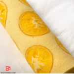 Delicious homemade Orange Cake Roll with zesty orange cream filling - a perfect dessert for any occasion.