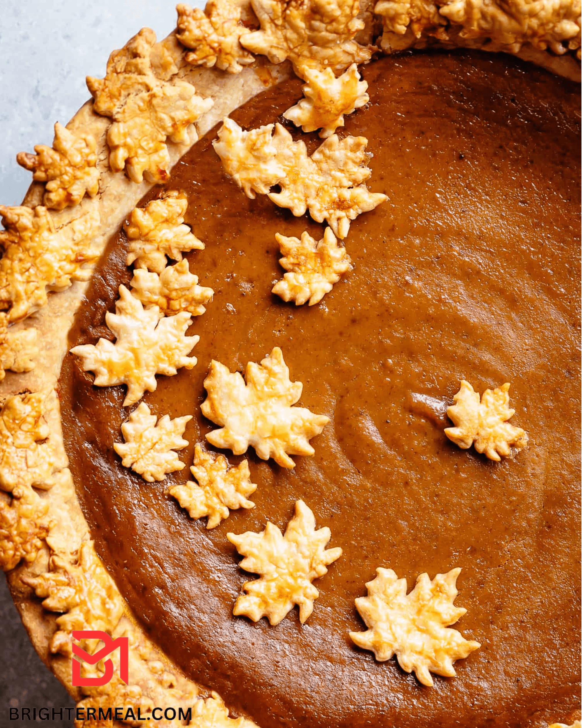 A golden-brown, perfectly baked pumpkin pie with a velvety smooth filling, embodying the essence of fall flavors. 🍂🥧 #FallDesserts #HomemadePie