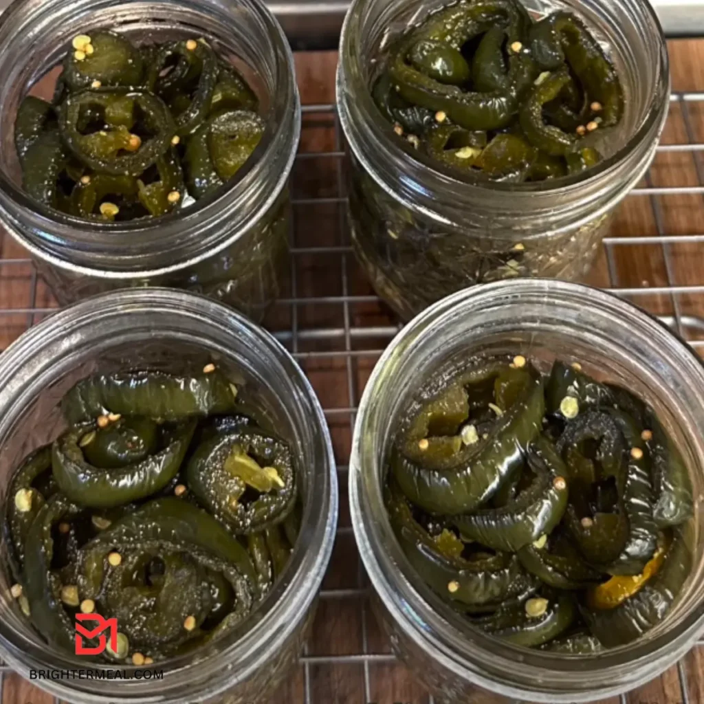 Close-up of homemade candied jalapeños on a wooden cutting board