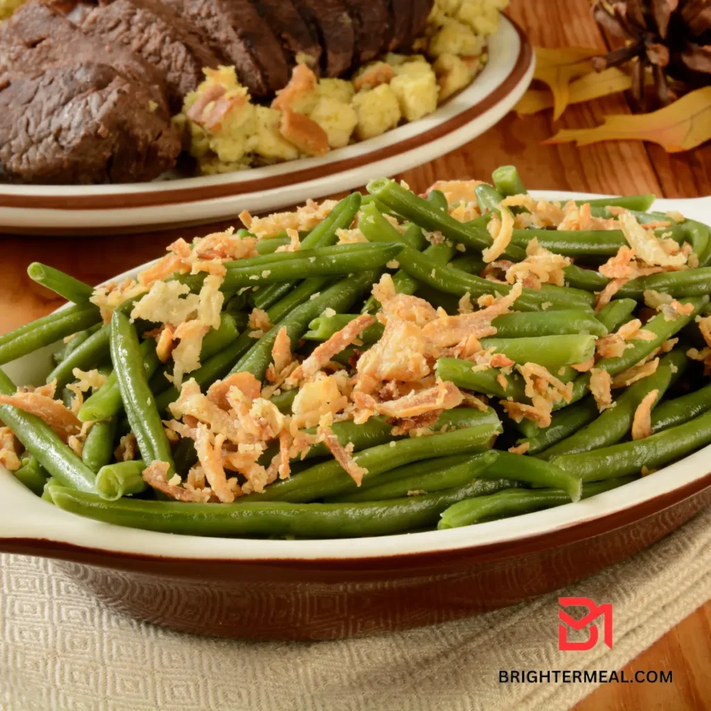 Green bean casserole in a baking dish, garnished with golden-brown onion strings