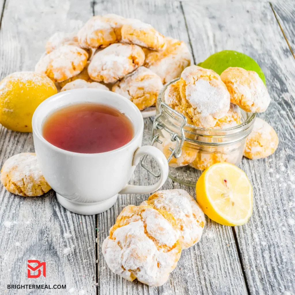 Zesty lemon cookies with a crinkled surface on parchment paper.