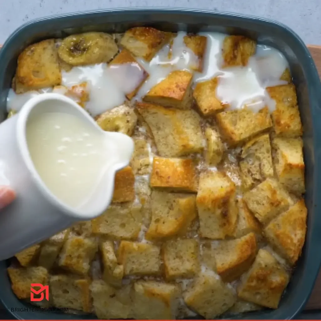 Sliced Banana Bread Pudding with a Drizzle of Sauce