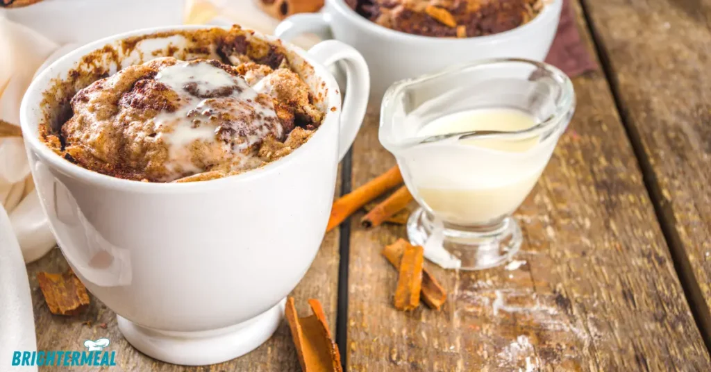 A steaming mug of dessert topped with fresh berries and a drizzle of honey.