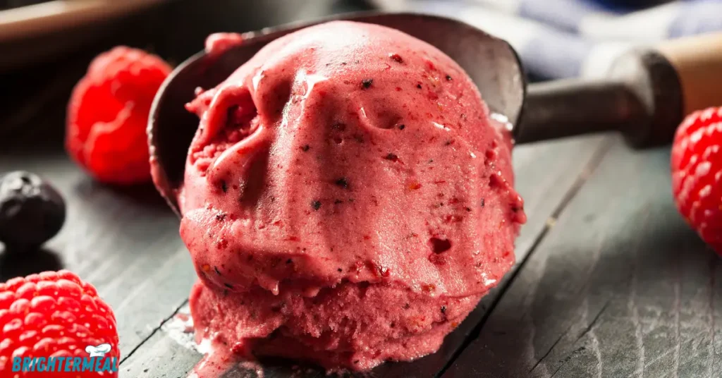 Fresh raspberries being blended into a smooth puree in a blender.
