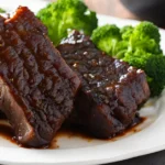 Tender boneless beef ribs served with a side of mashed potatoes.