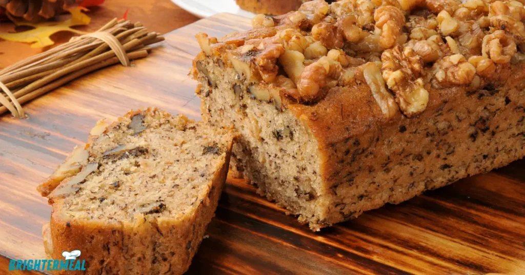 A slice of Starbucks Banana Bread, showing the soft and fluffy interior with bits of banana and walnuts.