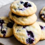 A baking tray with scoops of lemon blueberry cookie dough ready for the oven.