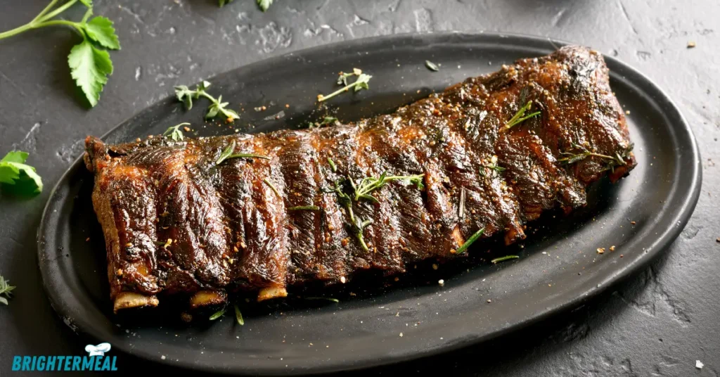 Juicy beef back ribs fresh off the grill with BBQ sauc