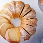 Freshly baked vanilla pound cake cooling on a wire rack
