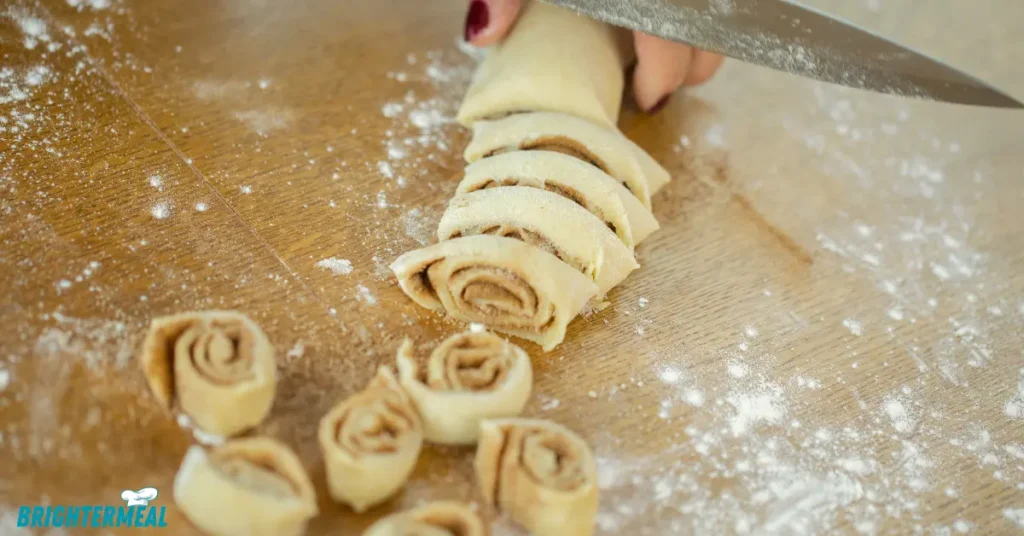 Golden brown cinnamon rolls cooling in the pan