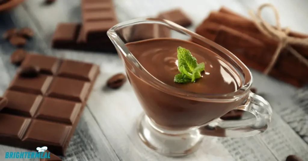 A spoon stirring smooth chocolate gravy.