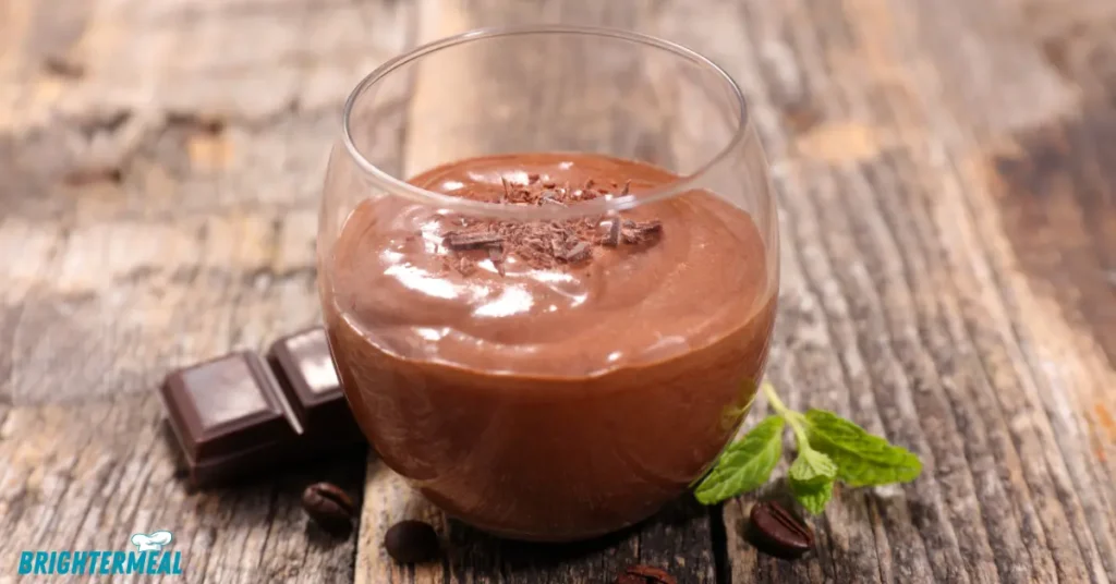 A bowl of rich chocolate gravy served with fresh biscuits.