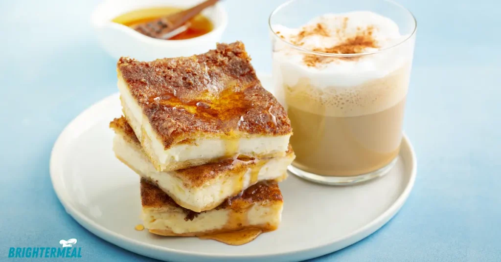Churro cheesecake bars drizzled with caramel sauce.