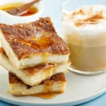 Churro cheesecake bars drizzled with caramel sauce.