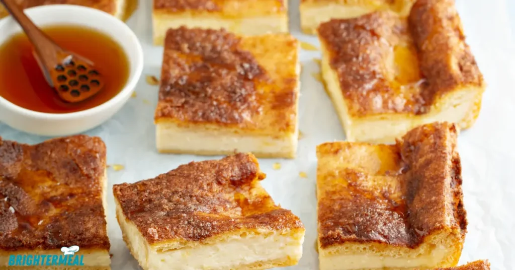 Sliced churro cheesecake bars served on a plate.