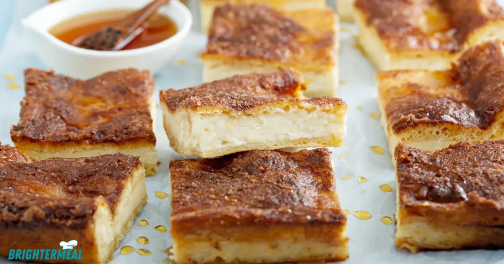 A close-up of the creamy cheesecake layer in the churro bars.