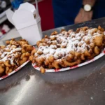Funnel cake with a scoop of vanilla ice cream