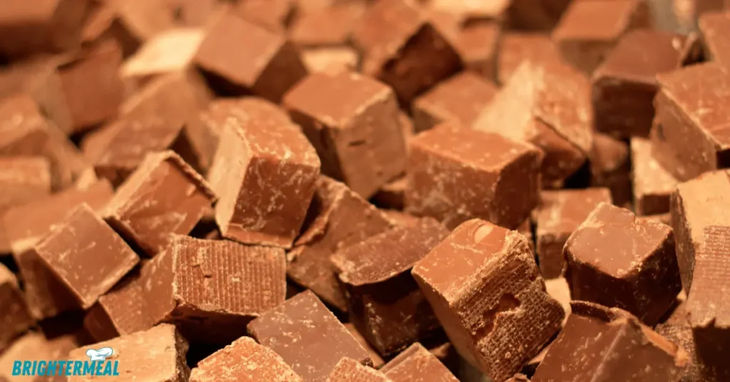 Ingredients for easy fudge recipe: sweetened condensed milk, chocolate chips, and vanilla extract.