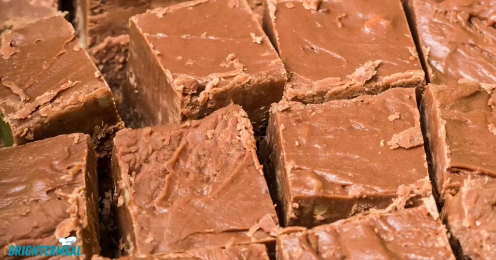 Fudge mixture being poured into a prepared pan.