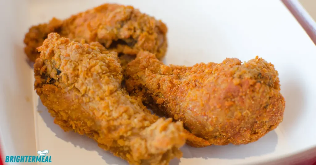 Chicken pieces marinating in buttermilk and spices.
