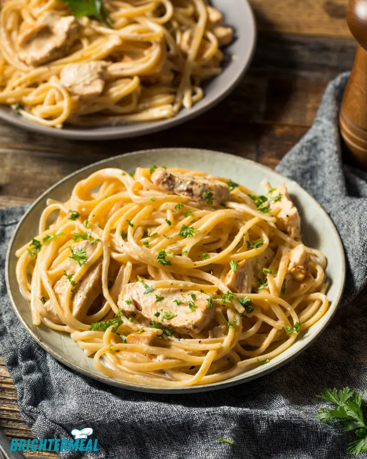 Cheesy chicken spaghetti casserole fresh out of the oven with golden crust.