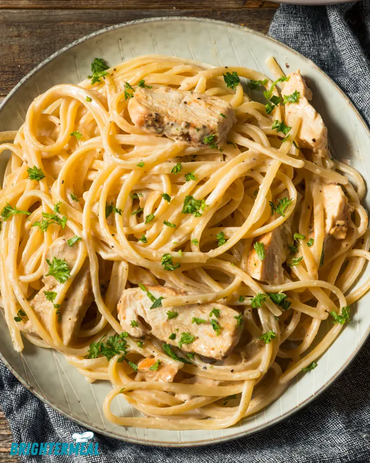 A family dinner table featuring chicken spaghetti casserole and side dishes.