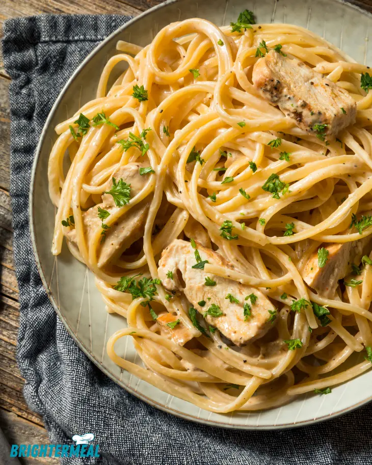 Step-by-step process of mixing chicken spaghetti ingredients in a large bowl.