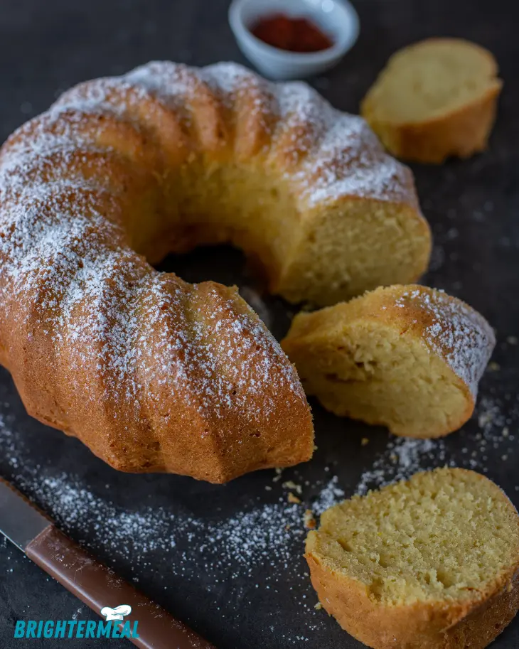 A beautifully glazed Vanilla Bundt Cake on a white plate, ready to serve.