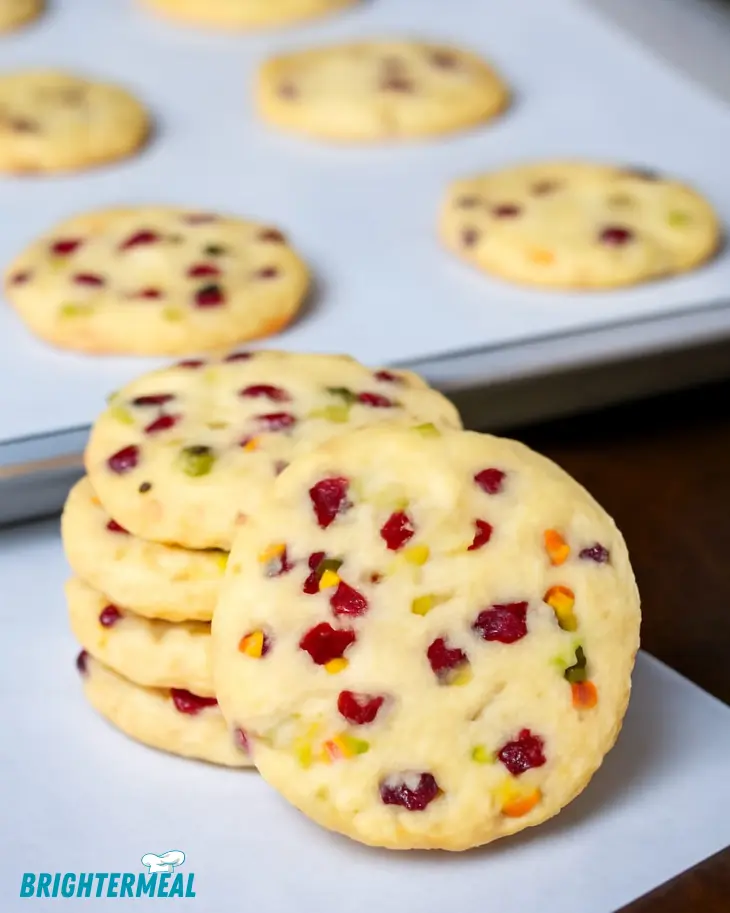 Freshly baked cranberry pistachio cookies cooling on a wire rack.